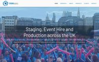 Staging Events homepage - a dark navy hero with a video background of a charity walk crowd, headline "Staging, Event Hire and Production across the UK"